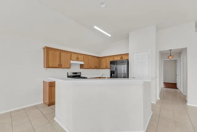 a kitchen with a sink a refrigerator and a stove