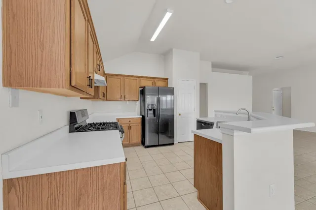 a kitchen with a sink stove and refrigerator