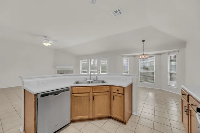 a kitchen with white cabinets and appliances