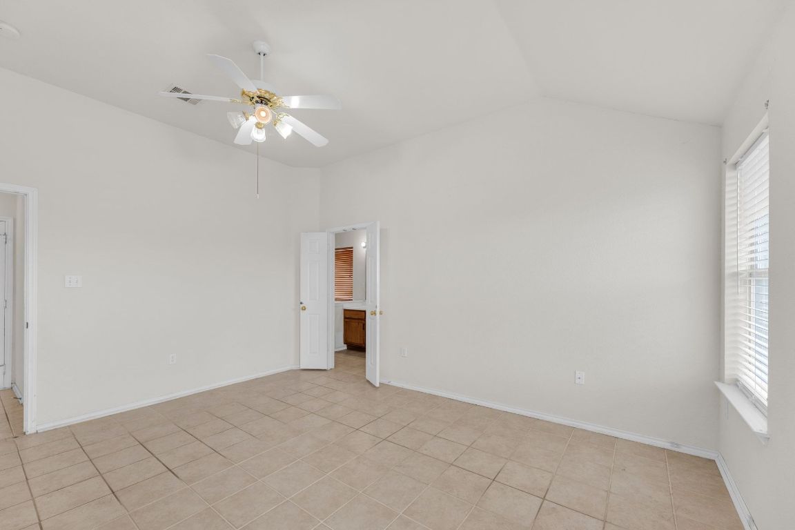 2317 Chestnut Path Round Rock, TX 78664 - Photo 19 of 36 Unfurnished room with vaulted ceiling, ceiling fan, and light tile patterned floors