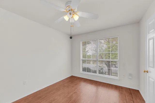 a view of an empty room with wooden floor