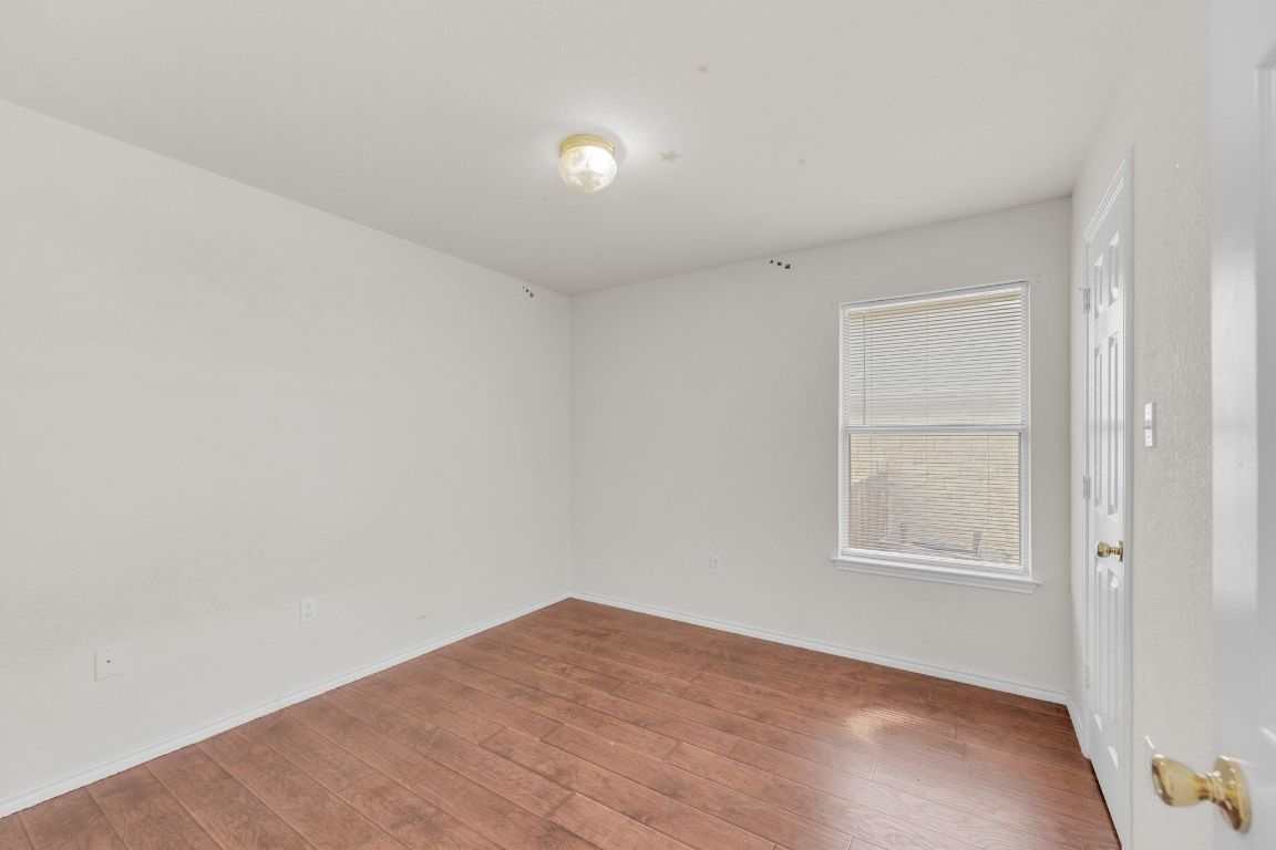 2317 Chestnut Path Round Rock, TX 78664 - Photo 28 of 36 Unfurnished room with baseboards and wood finished floors