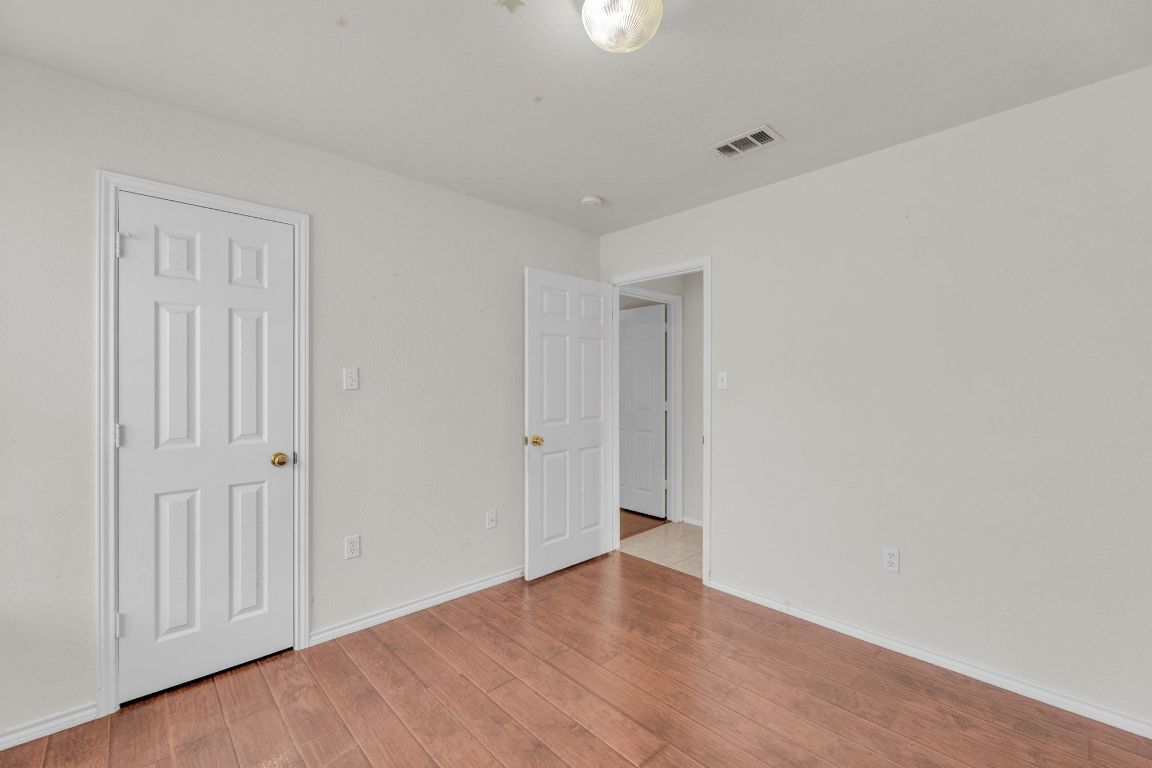 2317 Chestnut Path Round Rock, TX 78664 - Photo 29 of 36 Unfurnished bedroom with light wood finished floors and baseboards