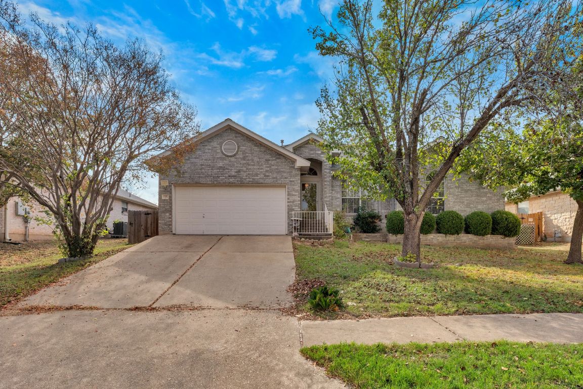 2317 Chestnut Path Round Rock, TX 78664 - Photo 3 of 36 Single story home with brick siding, driveway, and an attached garage