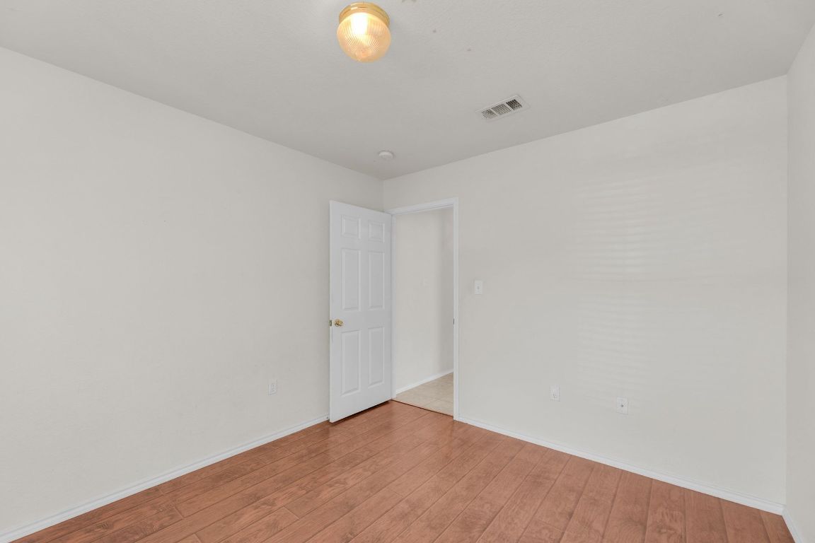 2317 Chestnut Path Round Rock, TX 78664 - Photo 31 of 36 Empty room featuring wood-type flooring and baseboards