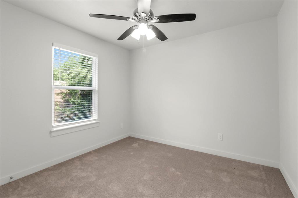 312 East Shepherd Street, Unit 312 Denison, TX 75021 - Photo 11 of 15 an empty room with a window and a fan