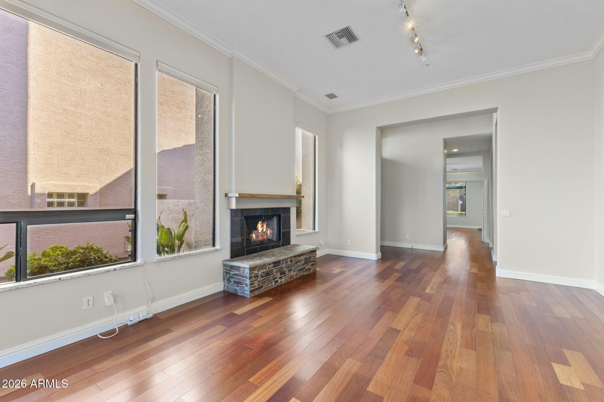 8100 East Camelback Road, Unit 43 Scottsdale, AZ 85251 - Photo 12 of 52 wooden floor fireplace and windows in an empty room