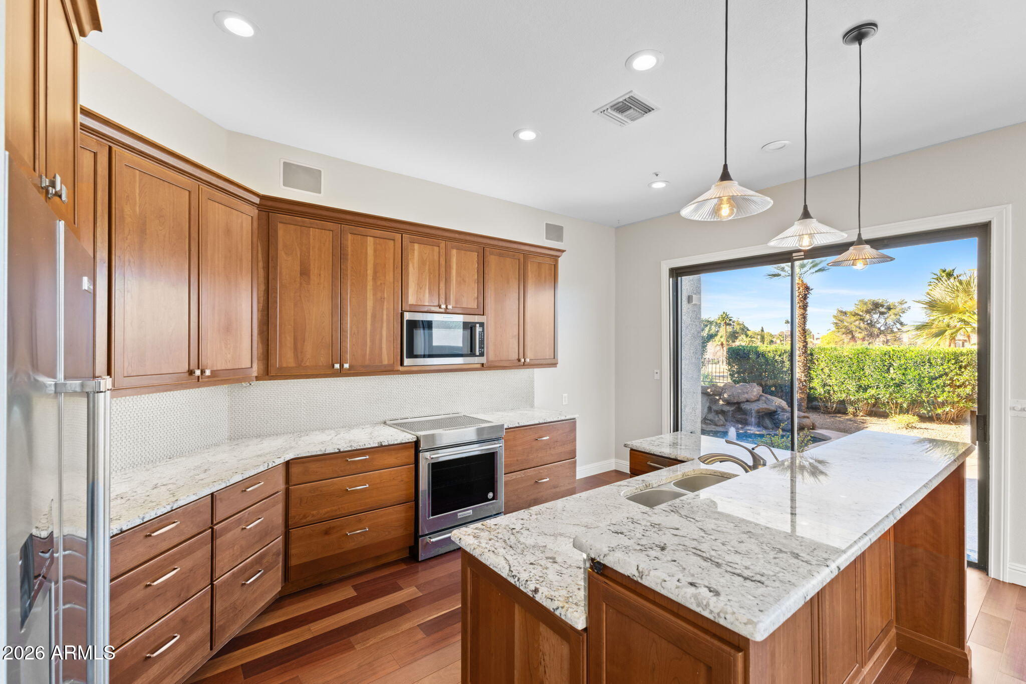 8100 East Camelback Road, Unit 43 Scottsdale, AZ 85251 - Photo 21 of 52 a kitchen with granite countertop a stove and a sink