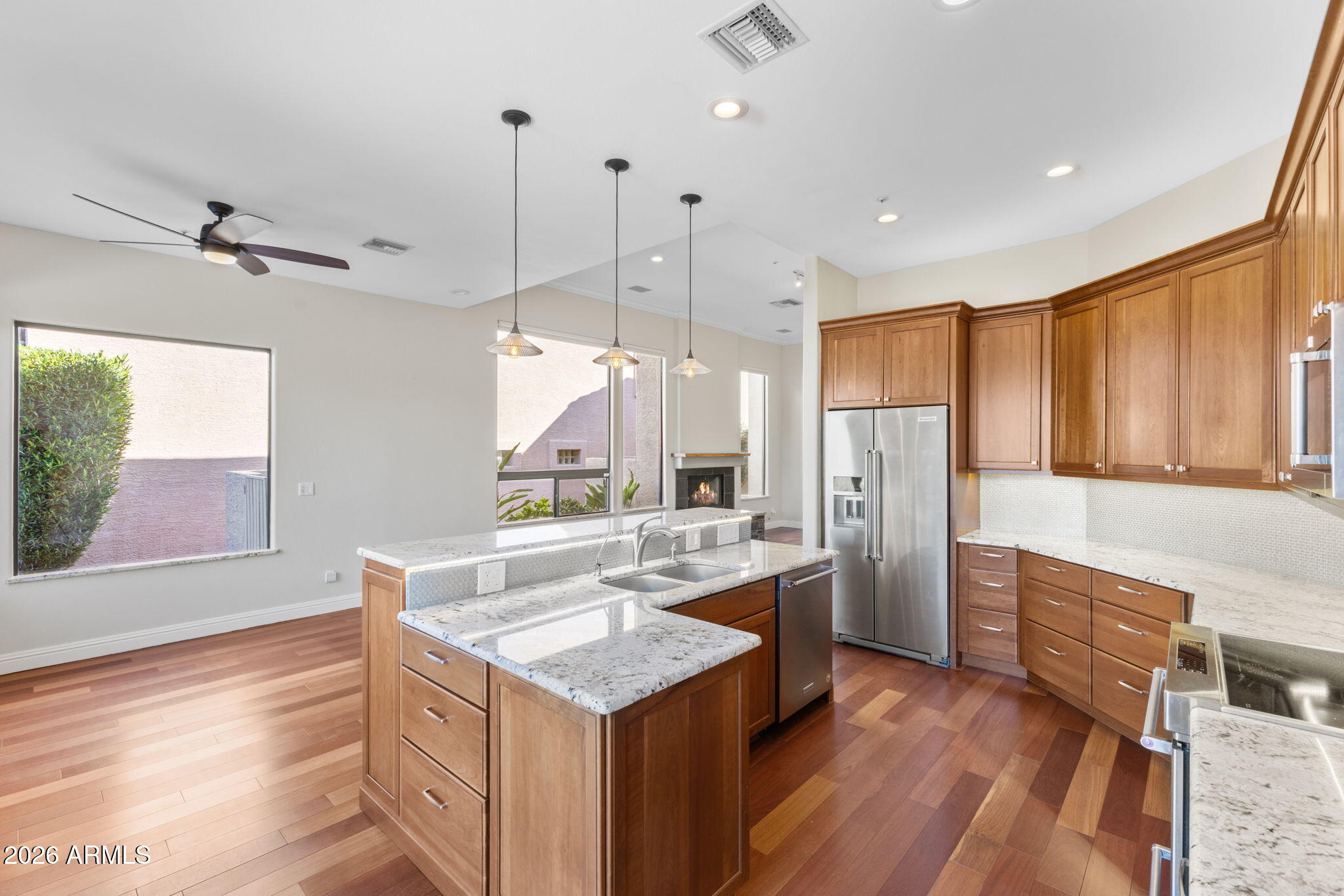 8100 East Camelback Road, Unit 43 Scottsdale, AZ 85251 - Photo 22 of 52 a kitchen with refrigerator cabinets and wooden floor