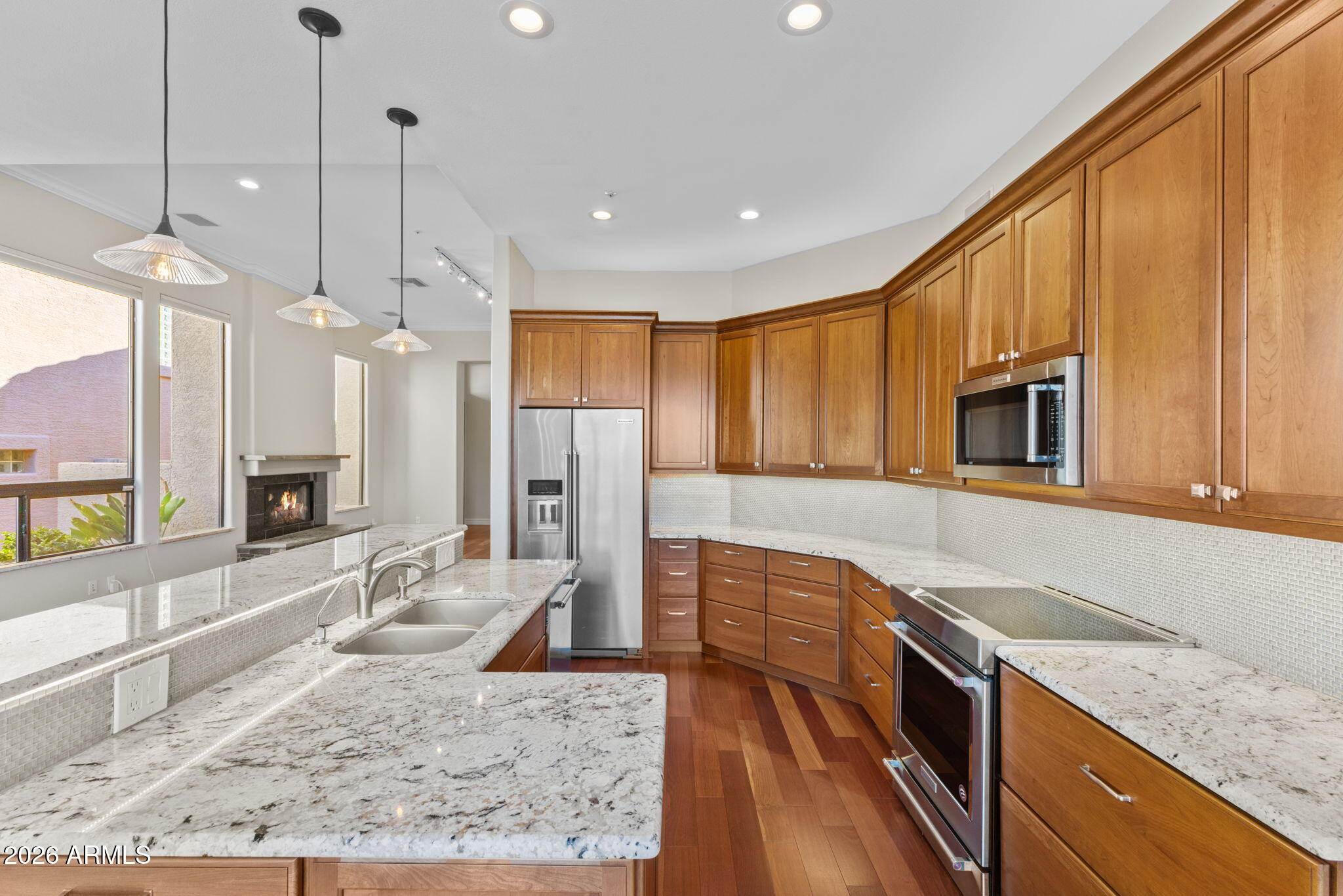 8100 East Camelback Road, Unit 43 Scottsdale, AZ 85251 - Photo 23 of 52 a kitchen with stainless steel appliances granite countertop a sink a stove and a wooden floors