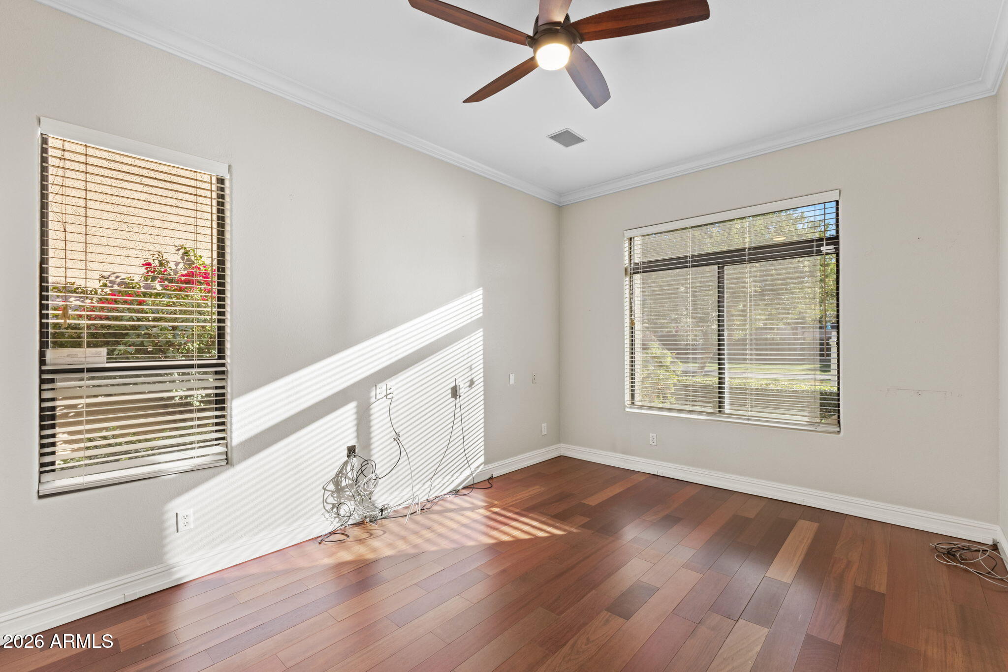 8100 East Camelback Road, Unit 43 Scottsdale, AZ 85251 - Photo 26 of 52 a view of an empty room with wooden floor and a window
