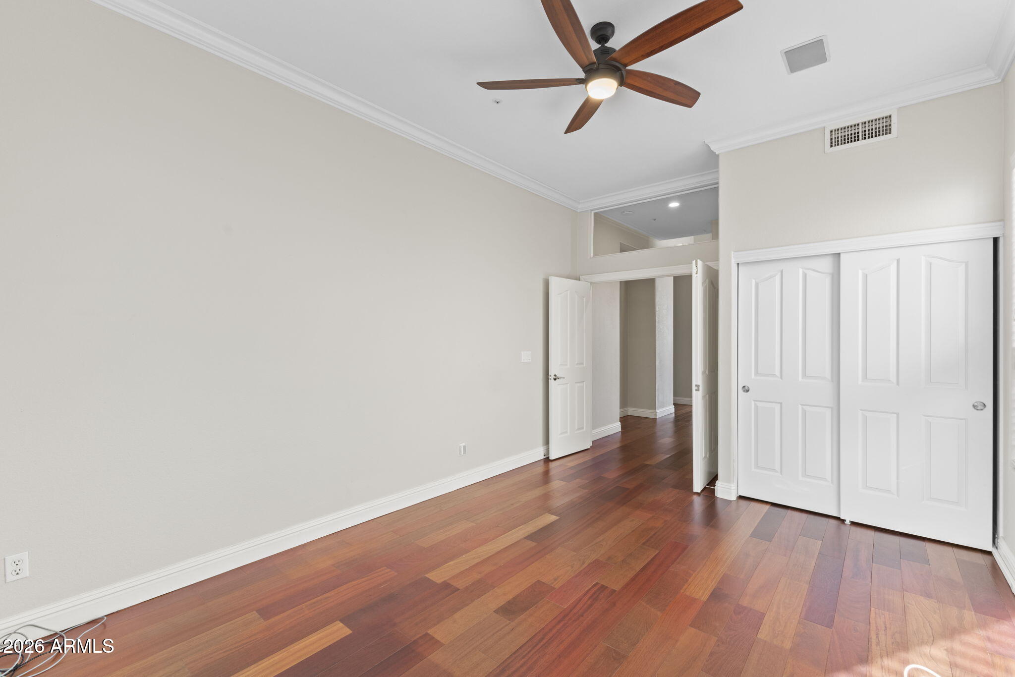8100 East Camelback Road, Unit 43 Scottsdale, AZ 85251 - Photo 27 of 52 an empty room with wooden floor and windows