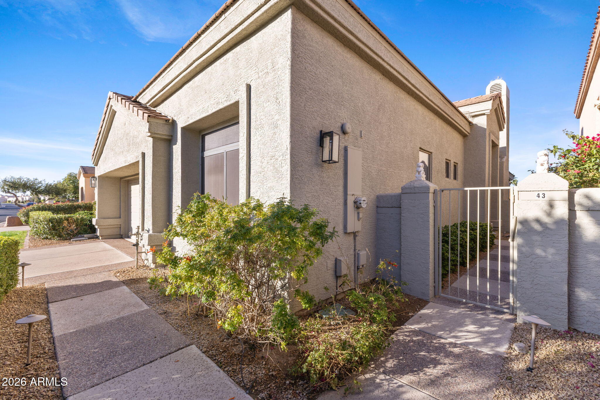 8100 East Camelback Road, Unit 43 Scottsdale, AZ 85251 - Photo 5 of 52 a front view of a house with garden