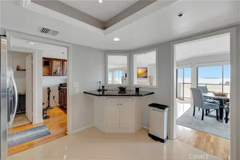 a kitchen with a sink stainless steel appliances and white cabinets