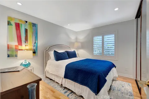 a bedroom with a large bed and a large window