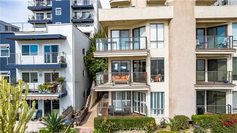 a front view of multi story residential apartment building with yard