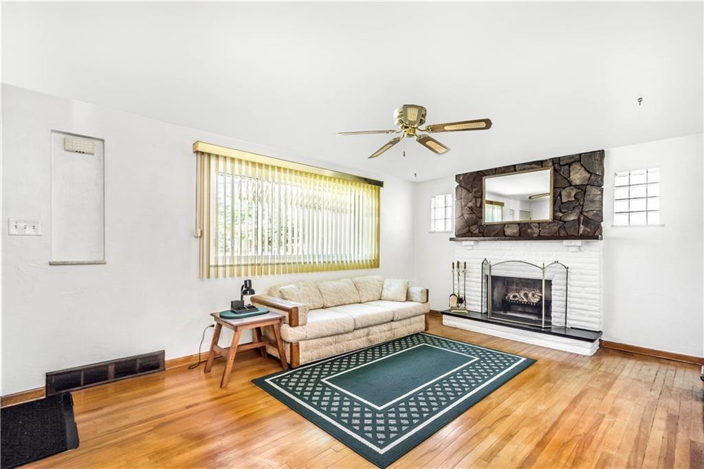41 Flora Road Pittsburgh, PA 15227 - Photo 4 of 25 Inside, you'll first enter the living room with original hardwood floors and attention grabbing fireplace!