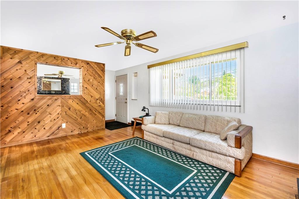 41 Flora Road Pittsburgh, PA 15227 - Photo 5 of 25 Across from the wood burning fireplace, a contemporary wood paneled wall creates a second focal point.
