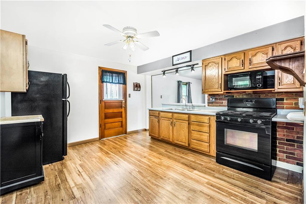 41 Flora Road Pittsburgh, PA 15227 - Photo 6 of 25 The large kitchen has wood floors and cool brick detail.