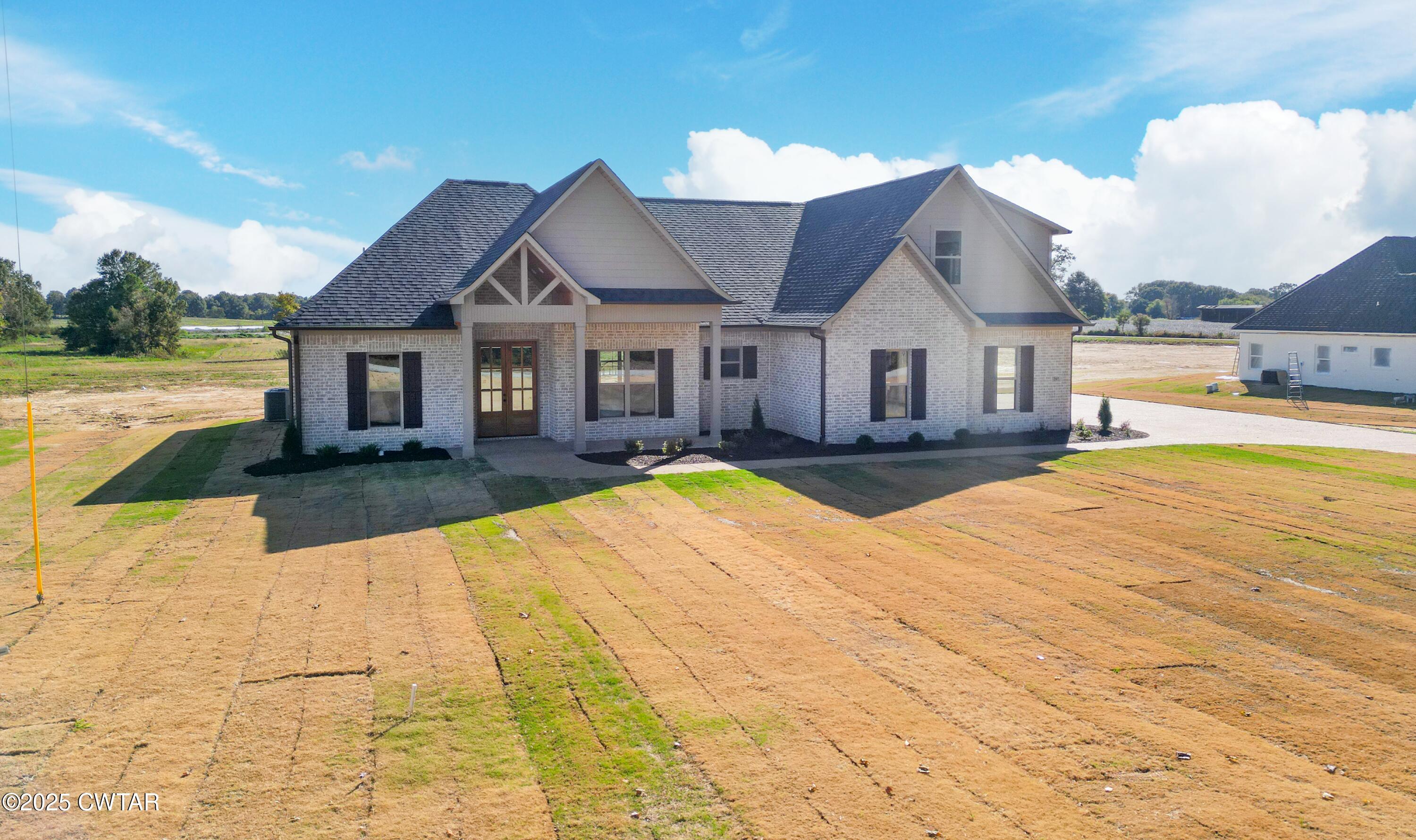 a view of a house with pool and yard
