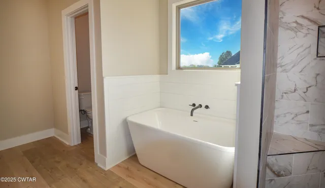 a spacious bathroom with a double vanity sink and a mirror