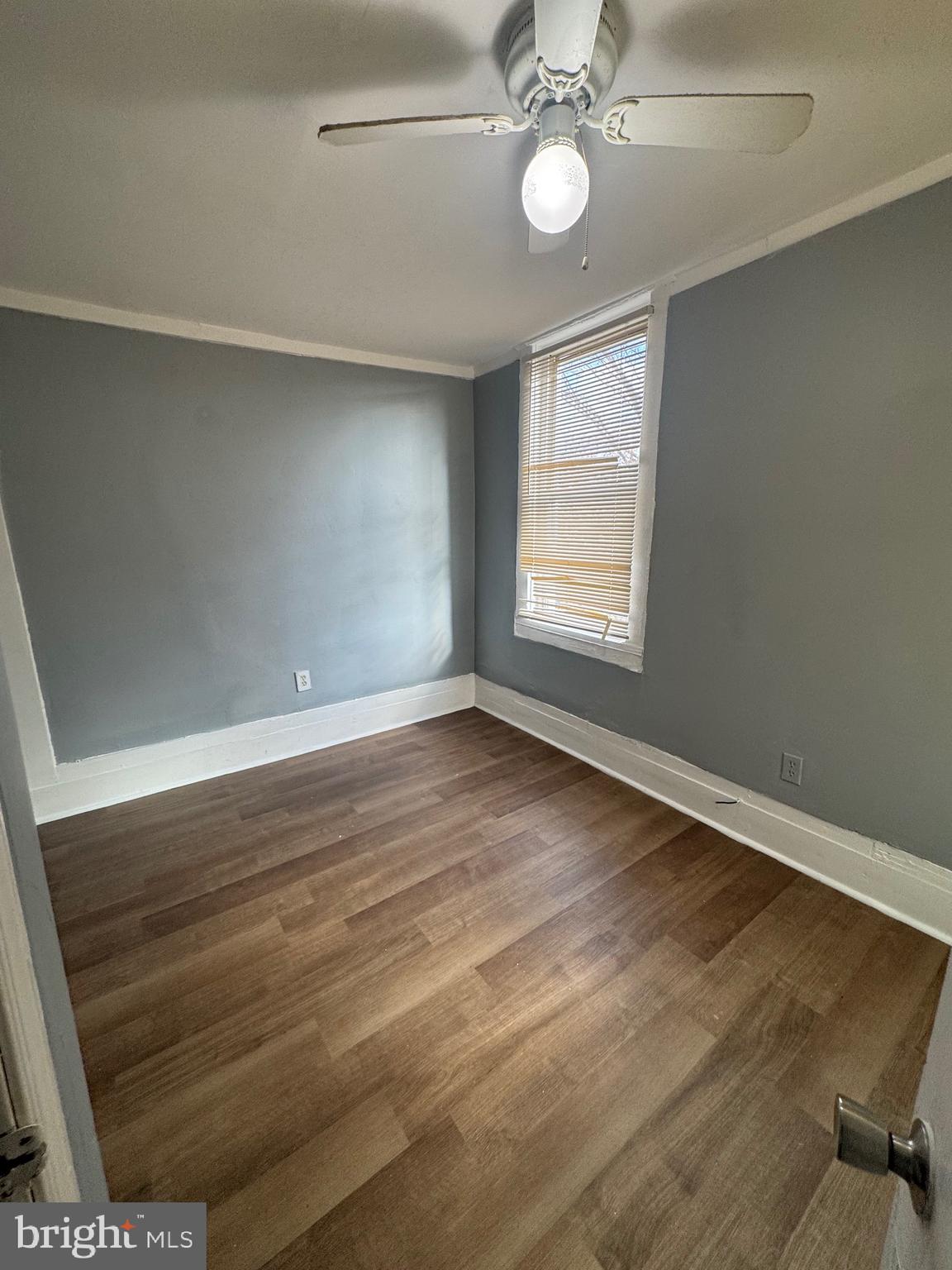 5000 Litchfield Avenue, Unit 2 Baltimore, MD 21215 - Photo 15 of 21 an empty room with wooden floor and windows