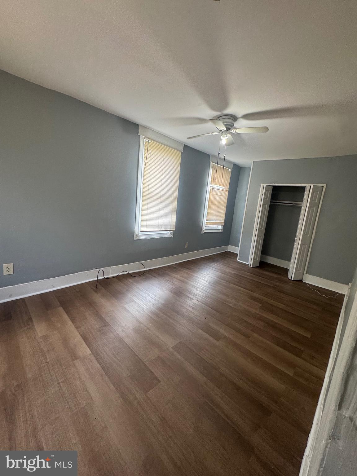 5000 Litchfield Avenue, Unit 2 Baltimore, MD 21215 - Photo 16 of 21 an empty room with wooden floor and windows