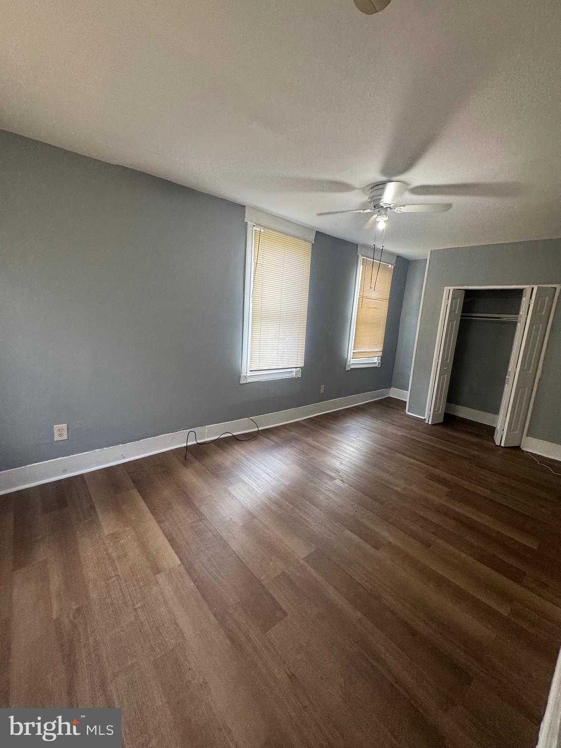 5000 Litchfield Avenue, Unit 2 Baltimore, MD 21215 - Photo 20 of 21 an empty room with wooden floor and windows