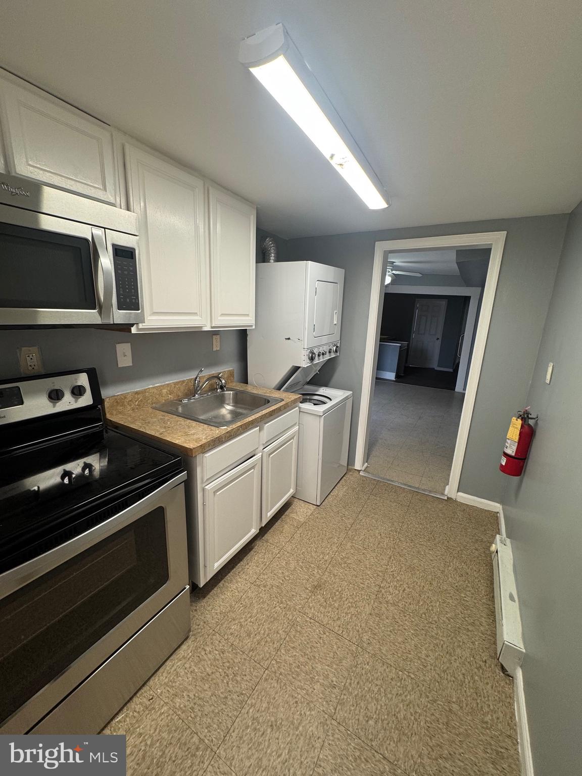 5000 Litchfield Avenue, Unit 2 Baltimore, MD 21215 - Photo 5 of 21 a kitchen with granite countertop a stove and a sink