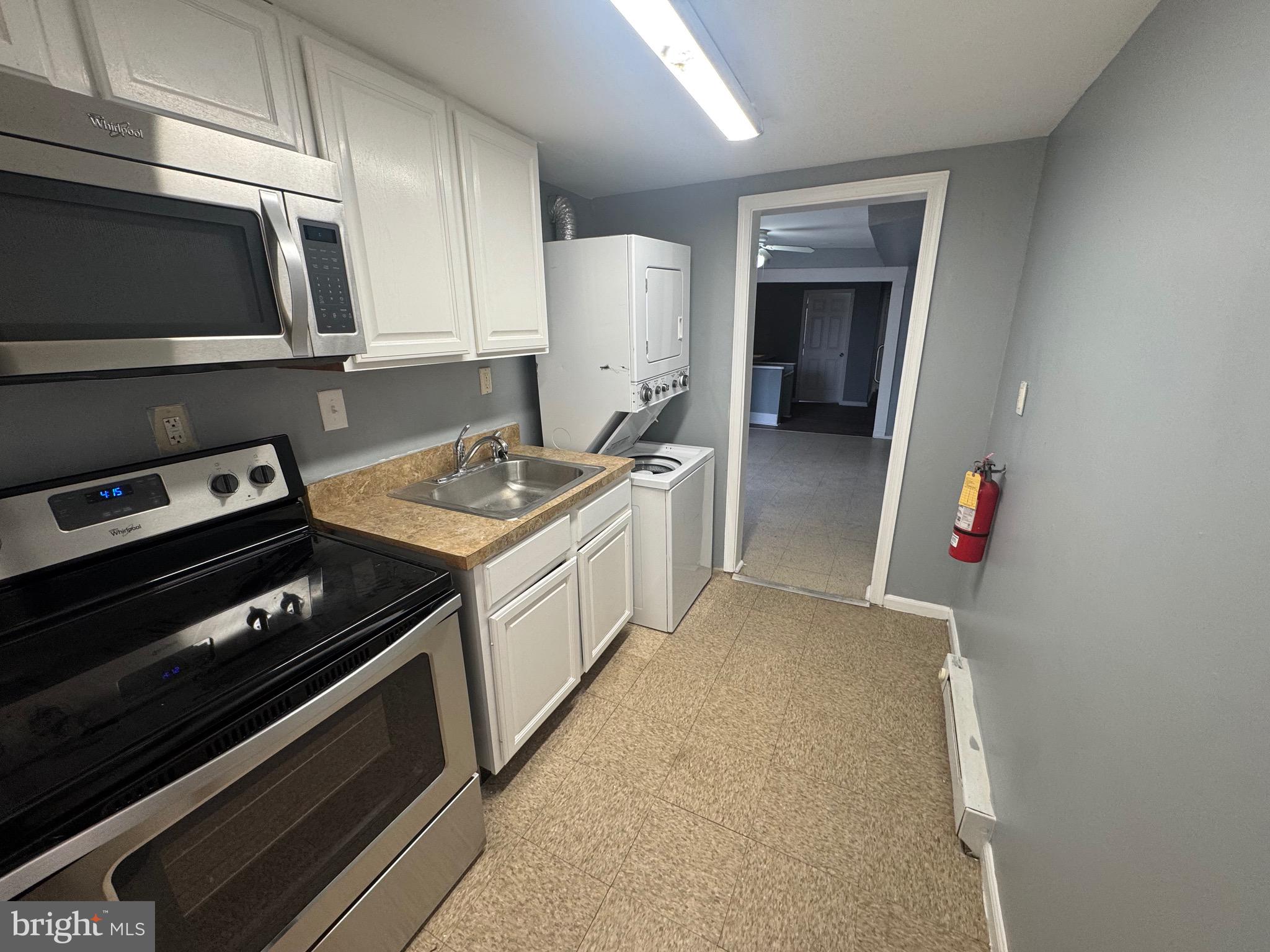 5000 Litchfield Avenue, Unit 2 Baltimore, MD 21215 - Photo 6 of 21 a kitchen with a stove and a microwave