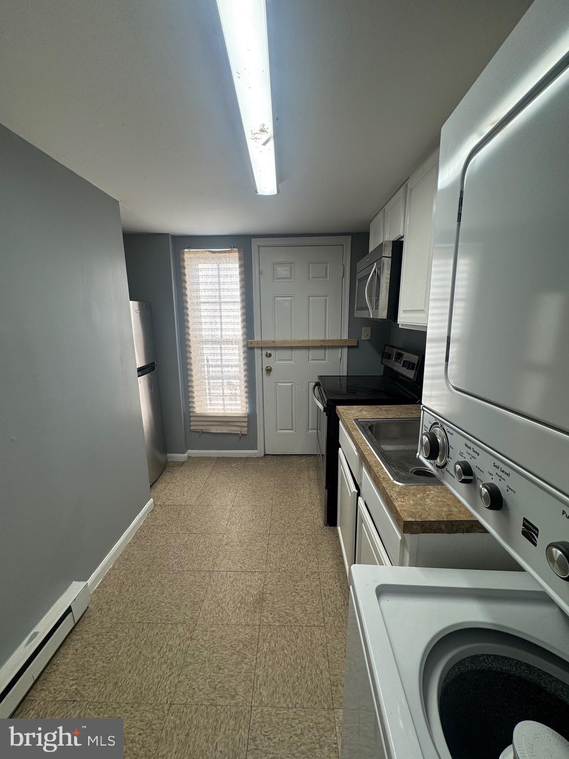 5000 Litchfield Avenue, Unit 2 Baltimore, MD 21215 - Photo 7 of 21 a kitchen that has a sink a stove and a wooden floor