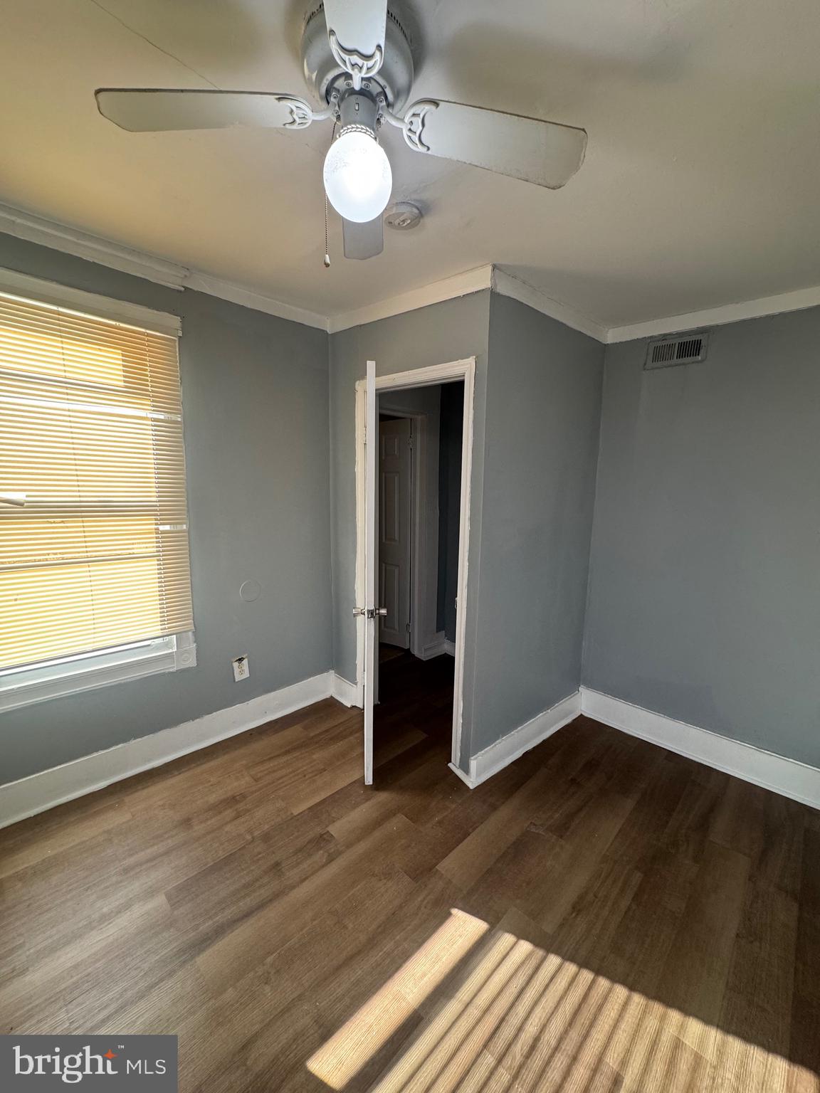 5000 Litchfield Avenue, Unit 2 Baltimore, MD 21215 - Photo 8 of 21 an empty room with wooden floor and windows