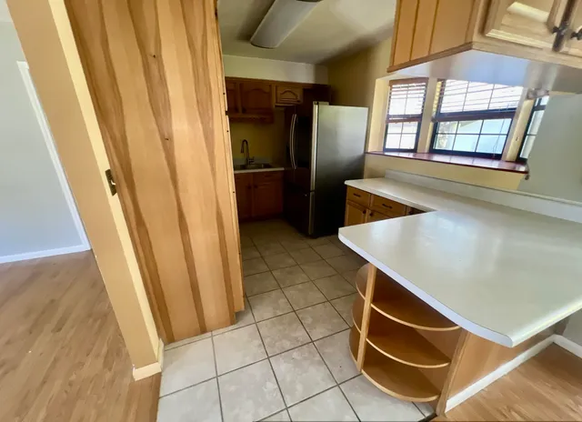 a view of kitchen with furniture and windows