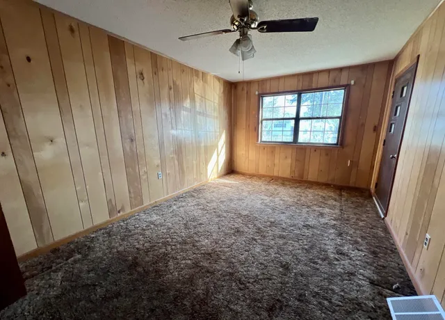 a view of room with window and a ceiling fan