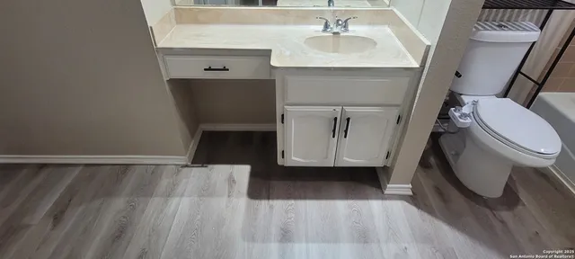 a bathroom with a sink a toilet and a mirror