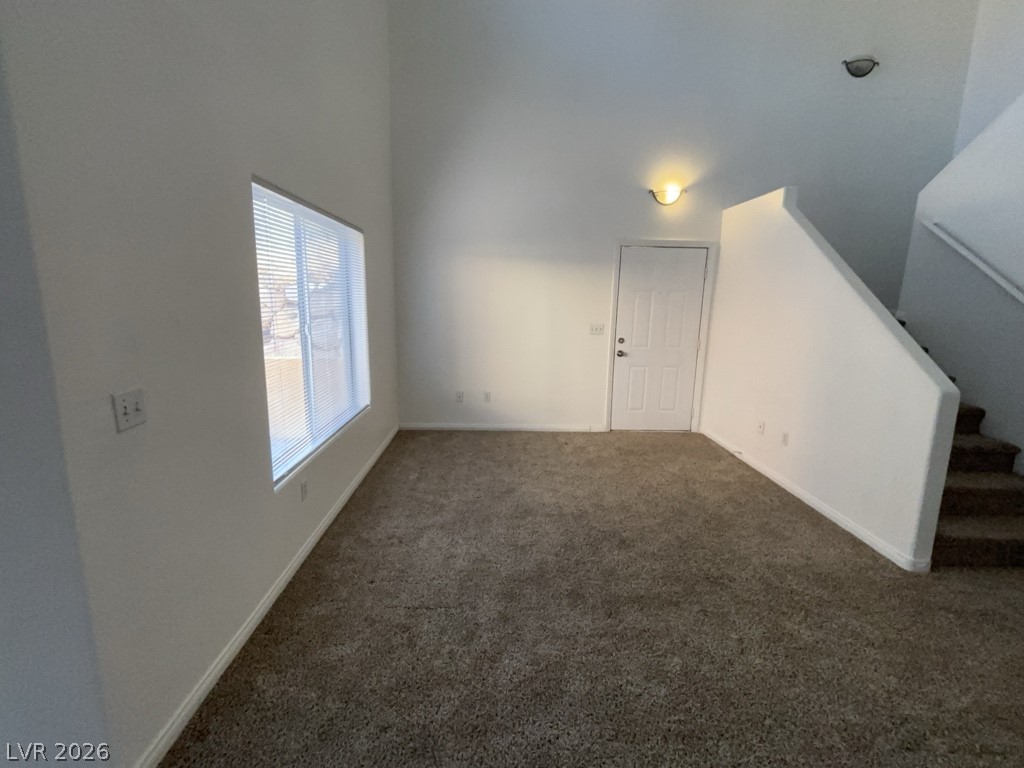 4915 East Russell Road, Unit 142 Las Vegas, NV 89120 - Photo 2 of 10 A spacious living area with high ceilings and plush carpeting awaits your personal touch.