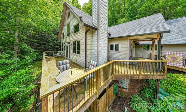 a view of house with outdoor space and trees