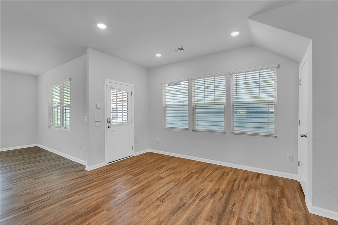 8 Leander Drive Greer, SC 29651 - Photo 20 of 31 Recessed lighting and numerous windows illuminate this versatile living area, perfect for personalization.