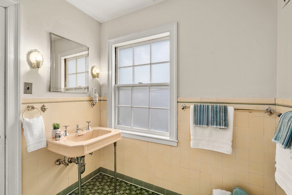 12 Ross Road Belmont, MA 02478 - Photo 21 of 33 a bathroom with a sink a mirror and a window