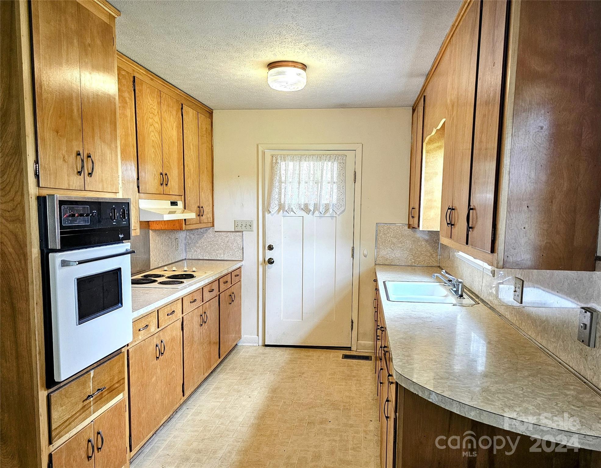1260 Bethel Road Morganton, NC 28655 - Photo 3 of 13 a kitchen with stainless steel appliances granite countertop a stove a sink and a refrigerator