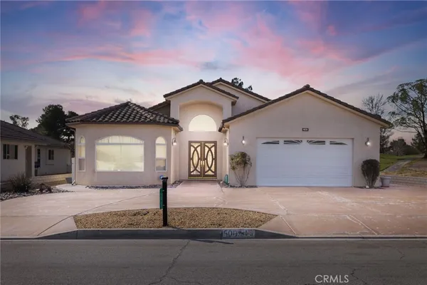 a front view of a house with yard
