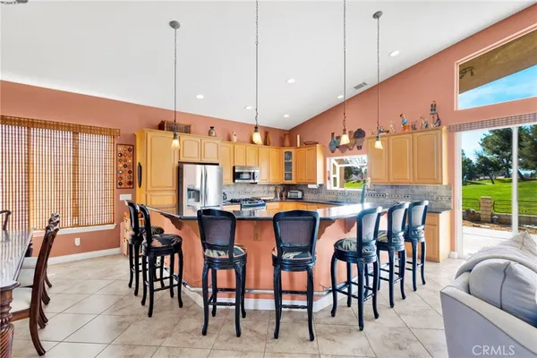 a kitchen with granite countertop a sink and a wooden floor