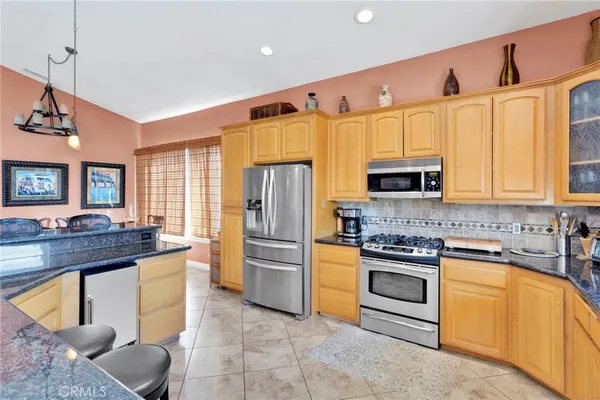 a kitchen that has a stove a sink and a wooden floor