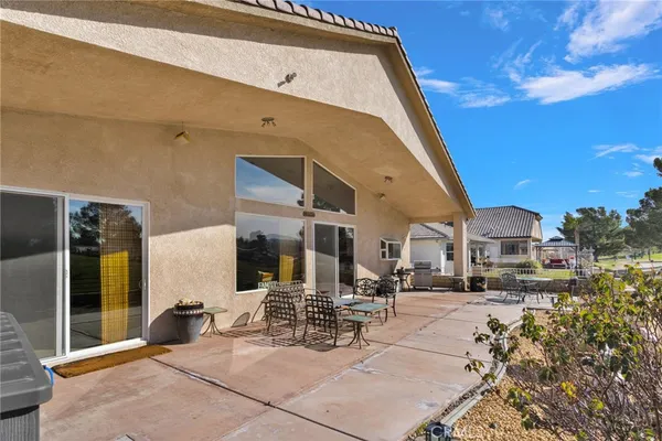 an aerial view of a house with outdoor space patio swimming pool and outdoor seating