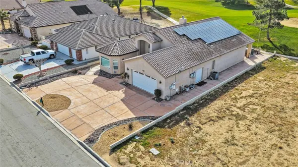 an aerial view of a house with a yard