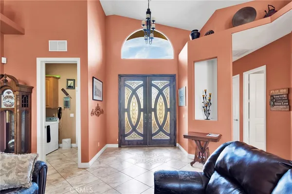 a living room with furniture and a floor to ceiling window
