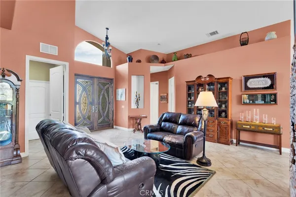 a living room with furniture a rug and a chandelier