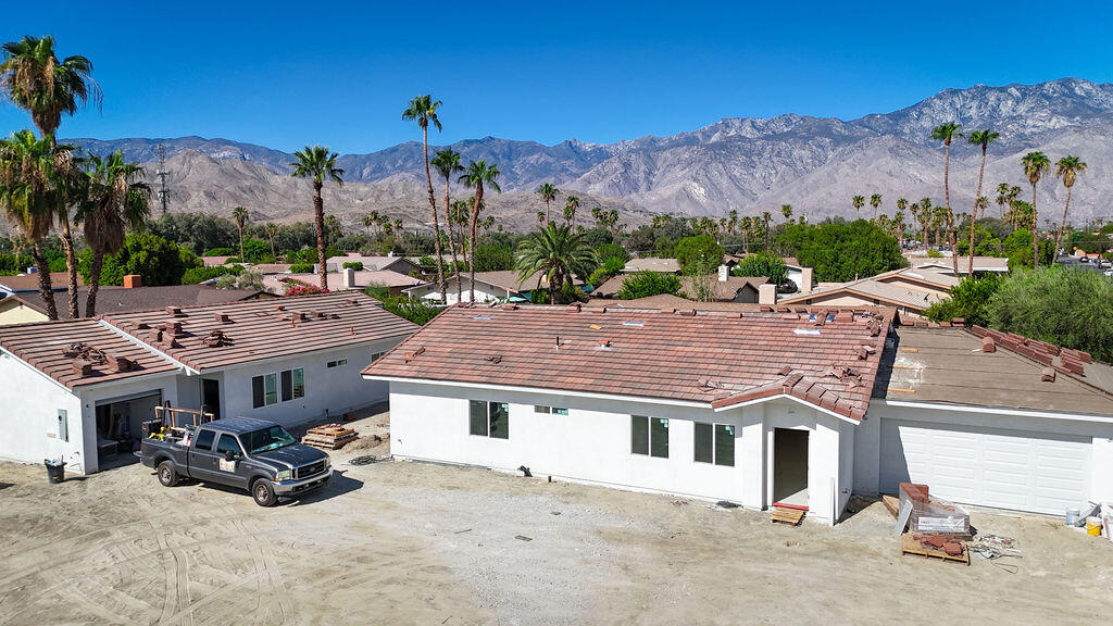 68855 Ortega Road Cathedral City, CA 92234 - Photo 2 of 19 a view of a house with a big yard and large trees