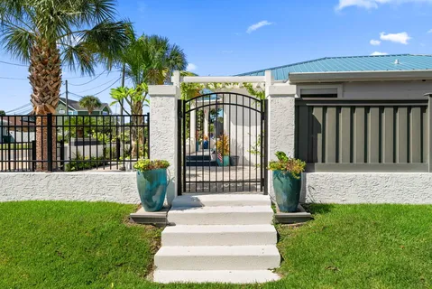 a view of a house with a yard and furniture