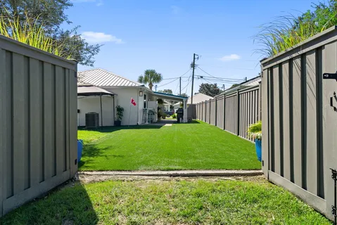 an aerial view of a residential houses with outdoor space and swimming pool